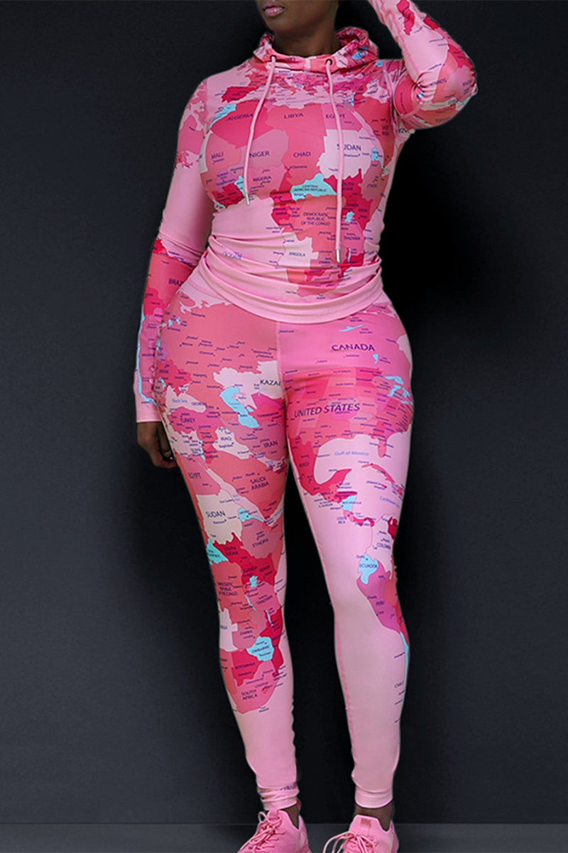 A woman wearing a fitted fitness  pink tights and matching pullover printed with world's map design with pink sneakers.