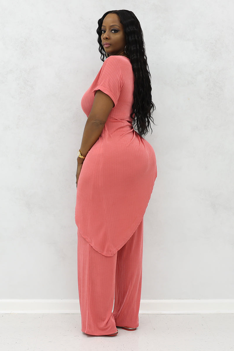 A woman wearing Mauve asymmetrical half sleeves long top with a modern, flowing design with matching pants.