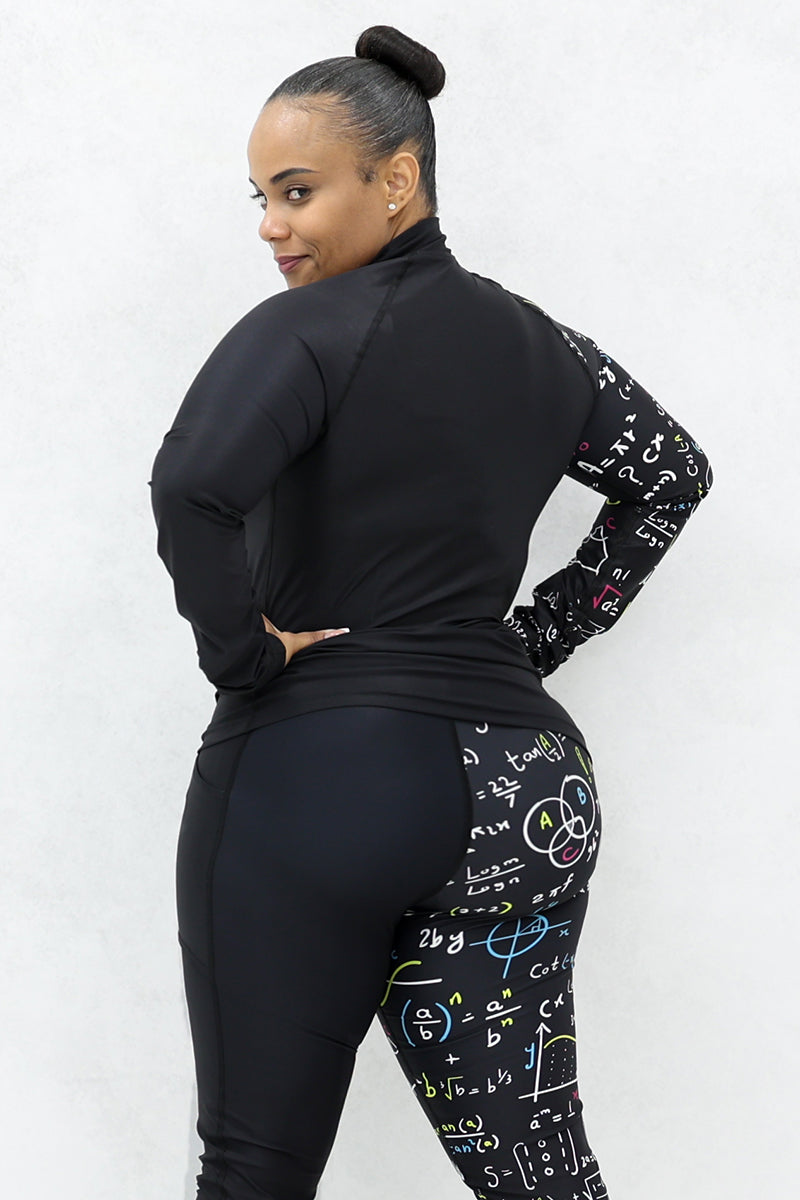 A woman wearing a black half-zip pullover and black tights both with multicolor math equations printed on one side.