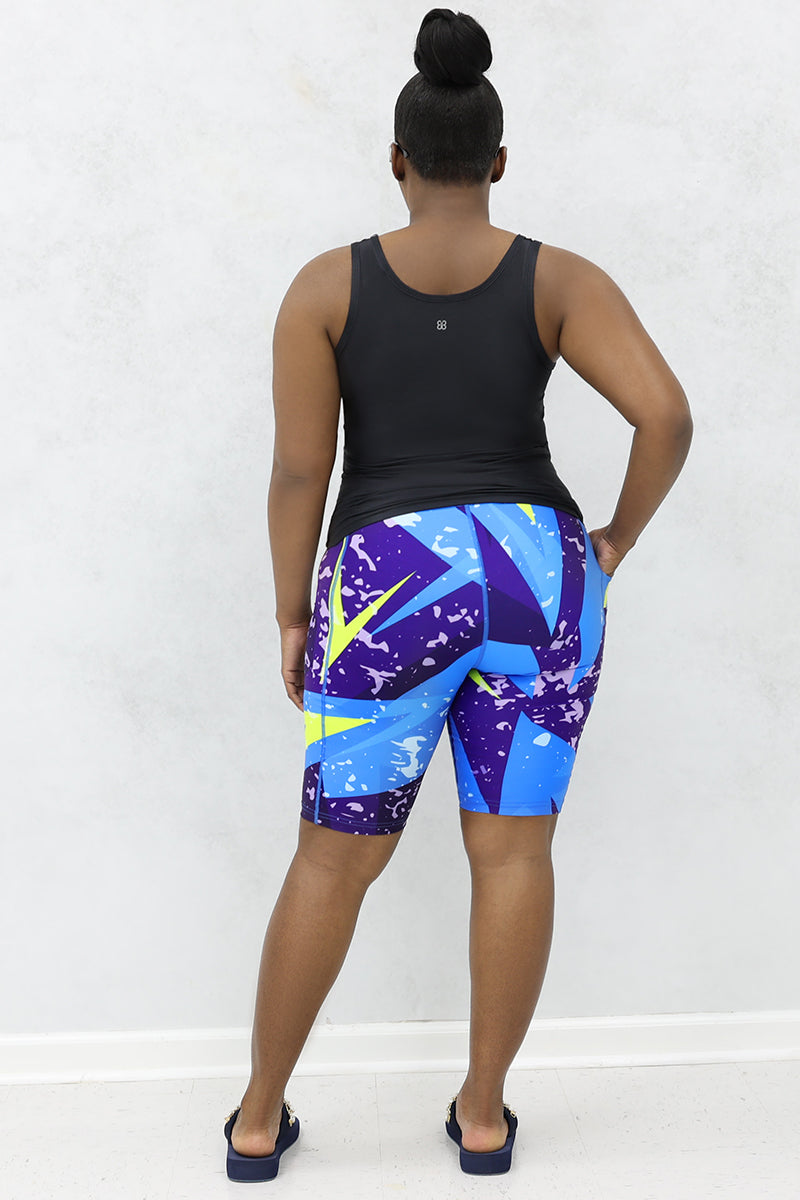 A stylish woman wearing a multi-colored Fusion Fly tank top.