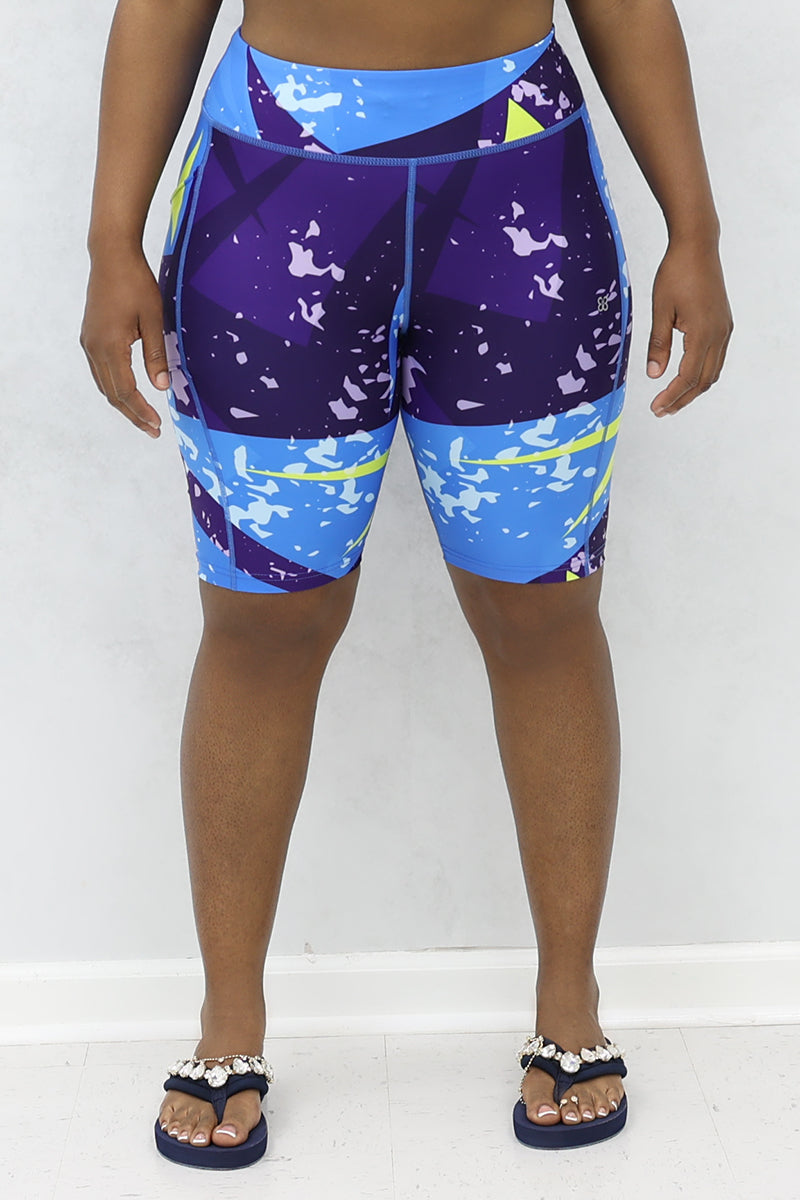 A stylish woman wearing multi-colored Fusion shorts.