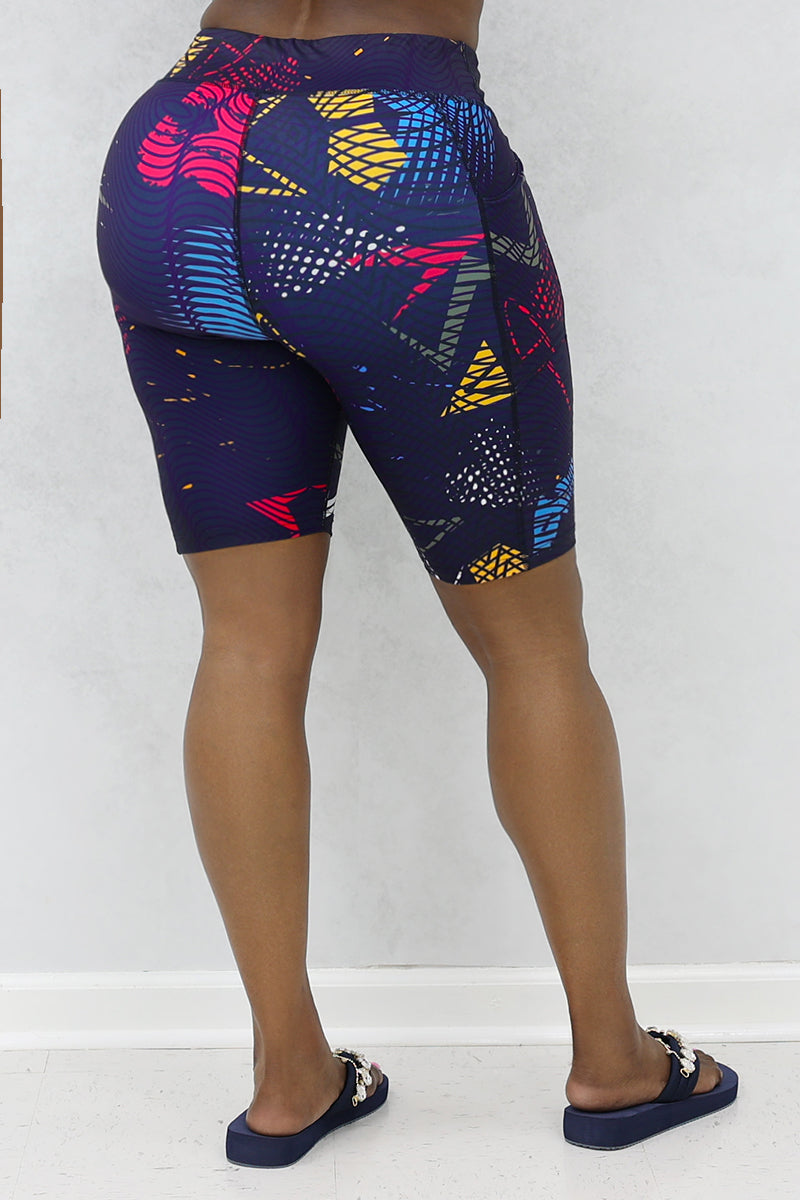 A stylish woman wearing multi-colored Genius shorts.
