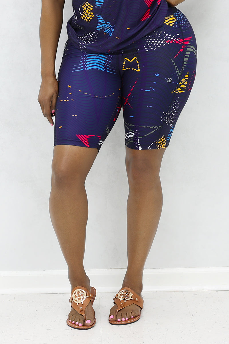 A stylish woman wearing multi-colored Genius shorts.