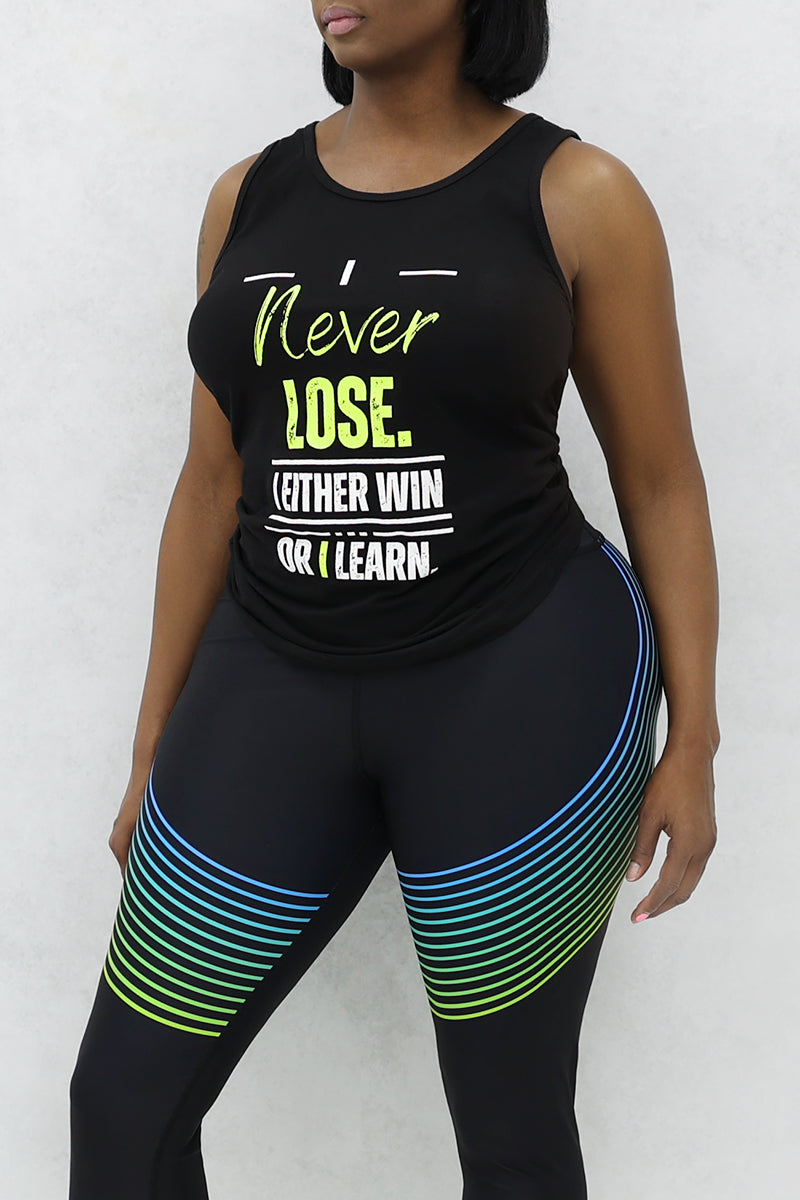A woman wearing a black 'I Never Lose' tank top made of stretchy polyester and spandex.