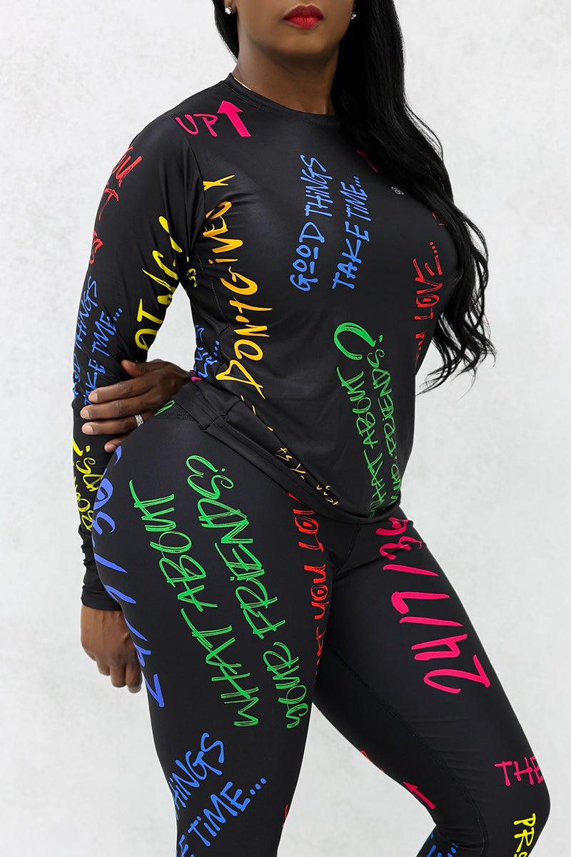 A woman wearing a Quote Long Sleeve T-Shirt in multi colors, designed for comfort with moisture-wicking fabric and inspiring quotes, perfect for exercise or casual wear.
