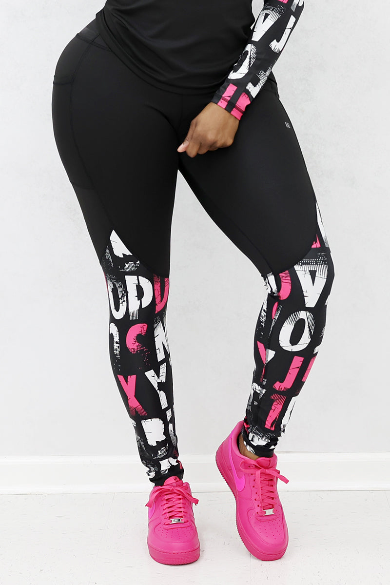A woman wearing pink and black School Tights made from stretchy polyester and spandex, featuring a continuous drawstring for a secure fit, perfect for a trendy and comfortable look.