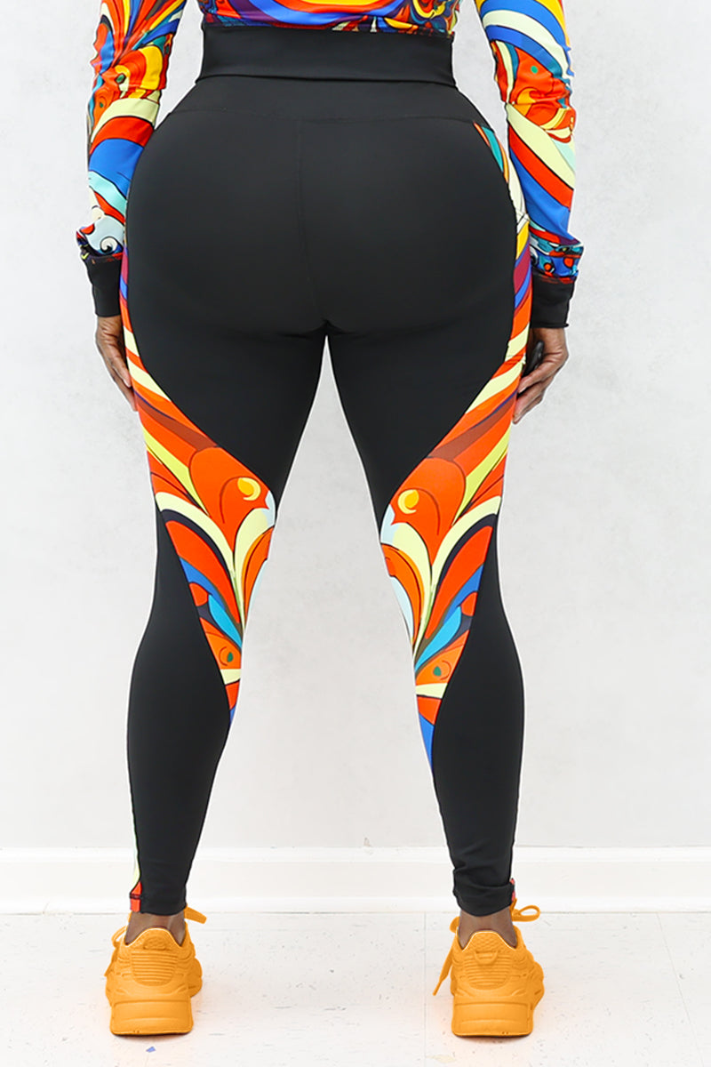 A woman wearing multi-colored Soul Train Tights featuring sleek black fabric with vibrant retro patterns, designed for comfort and performance during workouts or everyday activities.