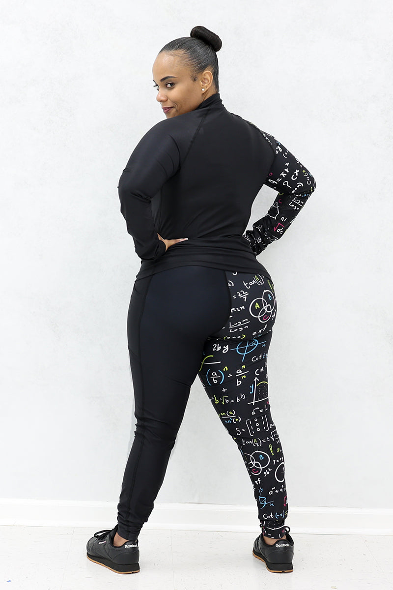 A woman wearing a black half-zip pullover and black tights both with multicolor math equations printed on one side and black shoes.