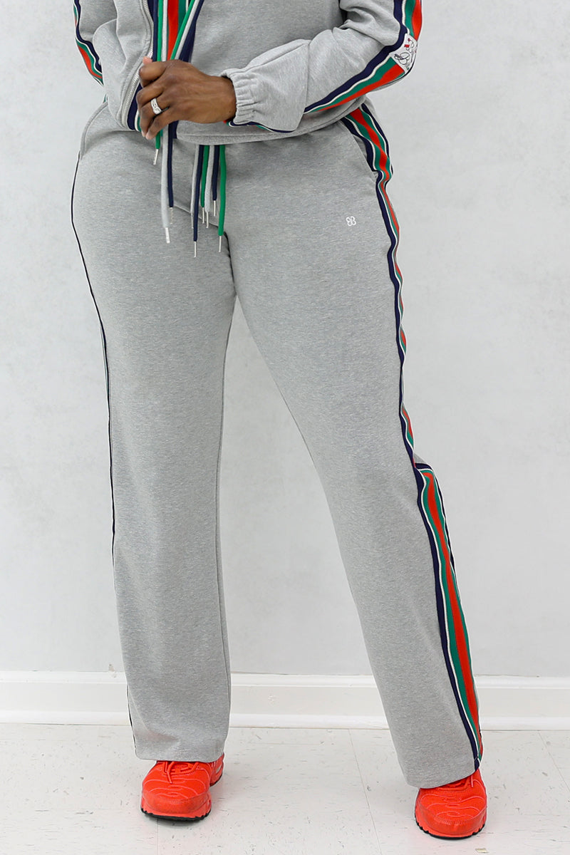 Woman wearing gray side stripe joggers with pockets and elastic waistband