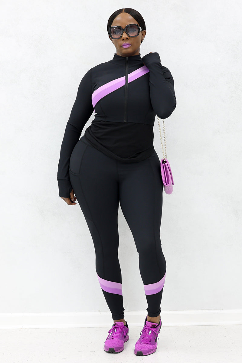 A woman wearing black and purple Ribbed Panel Cropped jacket paired with tights, purple shoes and a purse.