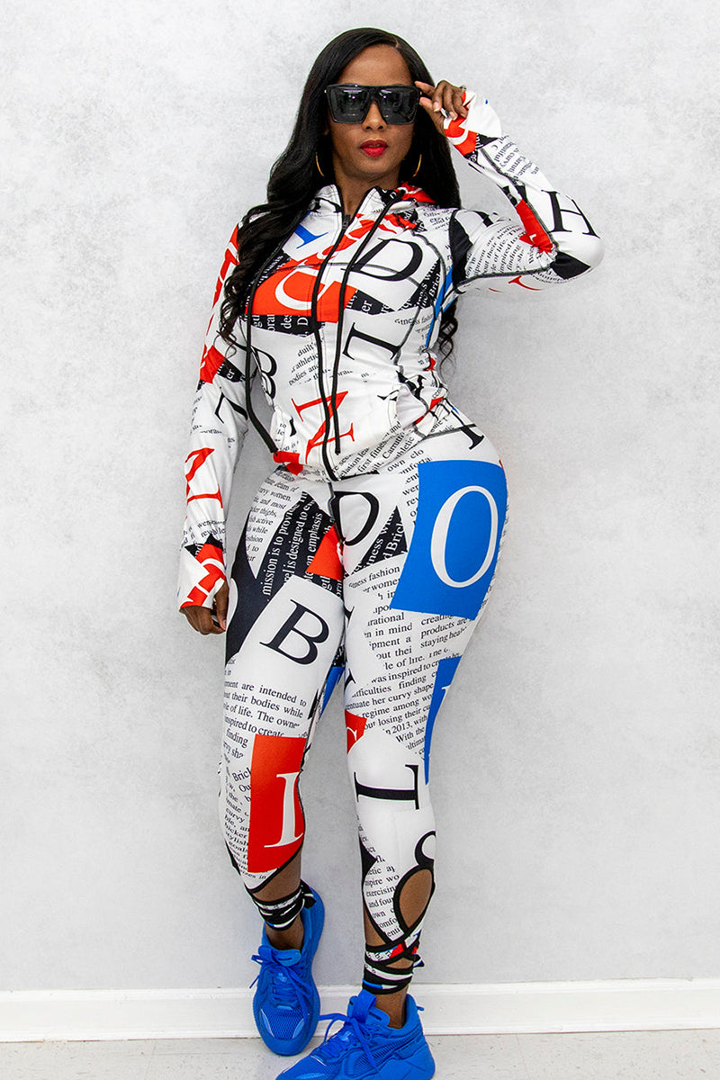 A woman’s fitted red, white, and blue fitness jacket with matching activewear capris. The capris have straps that tie around the ankle.