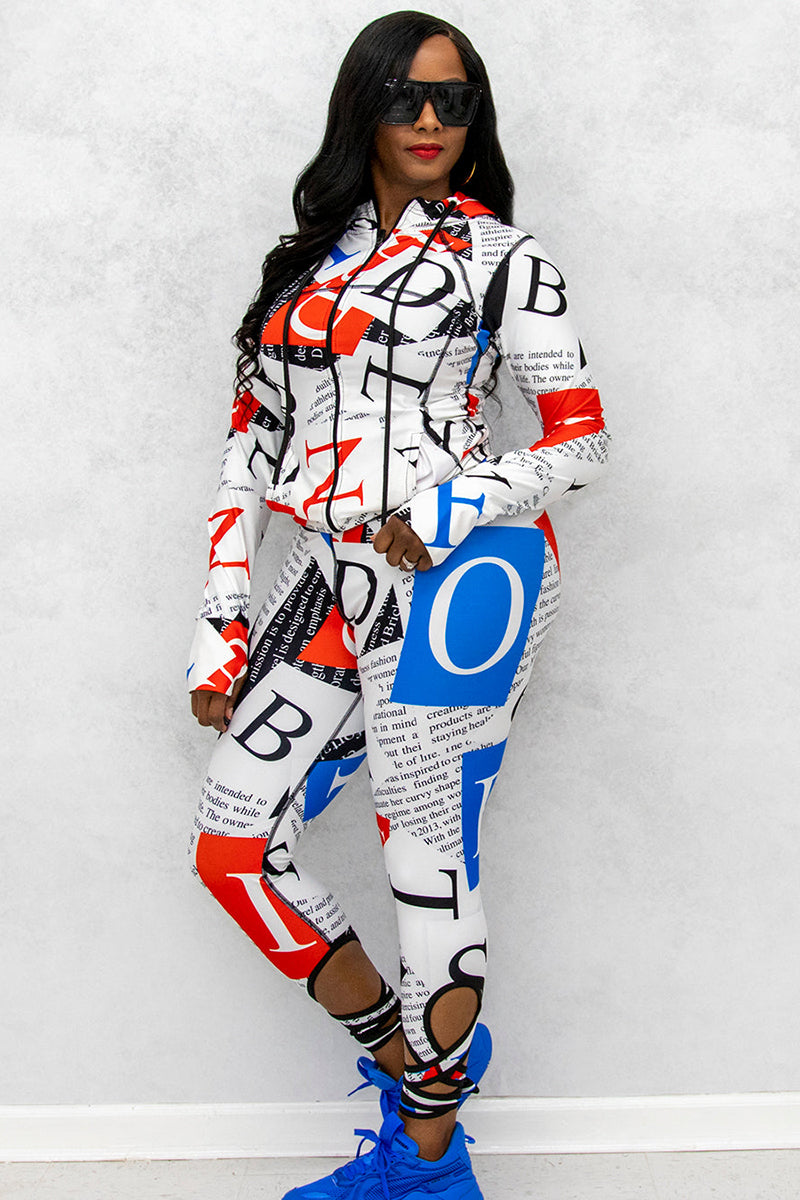 A woman’s fitted red, white, and blue fitness jacket with matching activewear capris. The capris have straps that tie around the ankle.