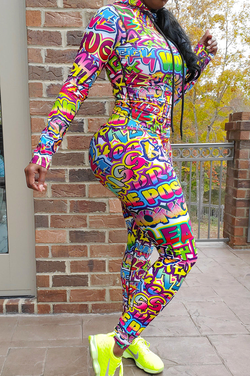A woman wearing multi-colored Graffiti tights featuring a unique design, side pockets, and a stretchy fit, ideal for workouts.