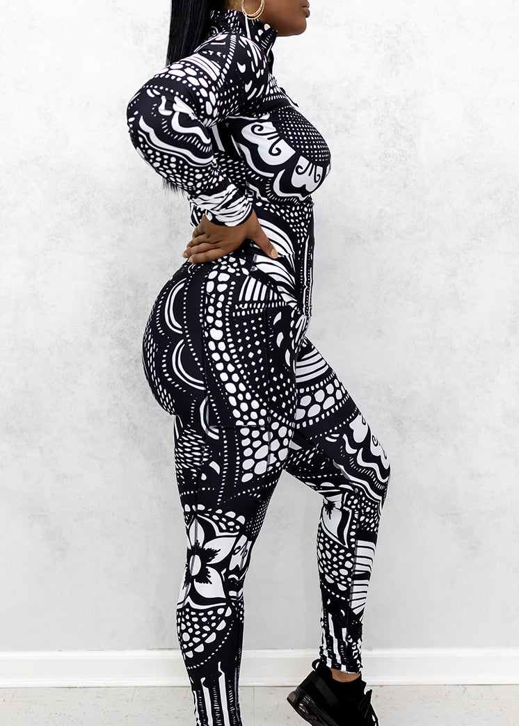 A woman wearing a black and white Journey Half-Zip Pullover, featuring a stylish design, stretchy fabric, and a convenient left arm pocket.