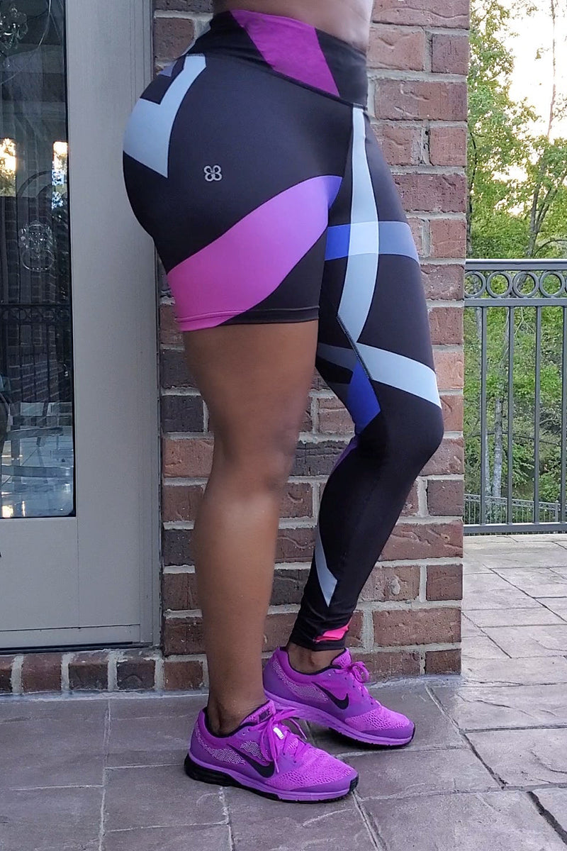 A woman wearing unique one-legged tights featuring vibrant ombre colors in pink-purple designed for individuality and comfort during workouts.