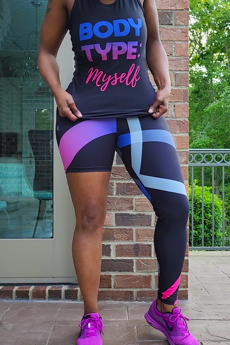 A woman wearing unique one-legged tights featuring vibrant ombre colors in pink-purplen designed for individuality and comfort during workouts.