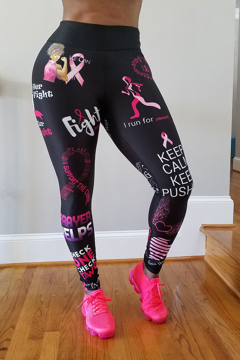 A girl wearing black tights with pink breast cancer awareness prints and pink running shoes.