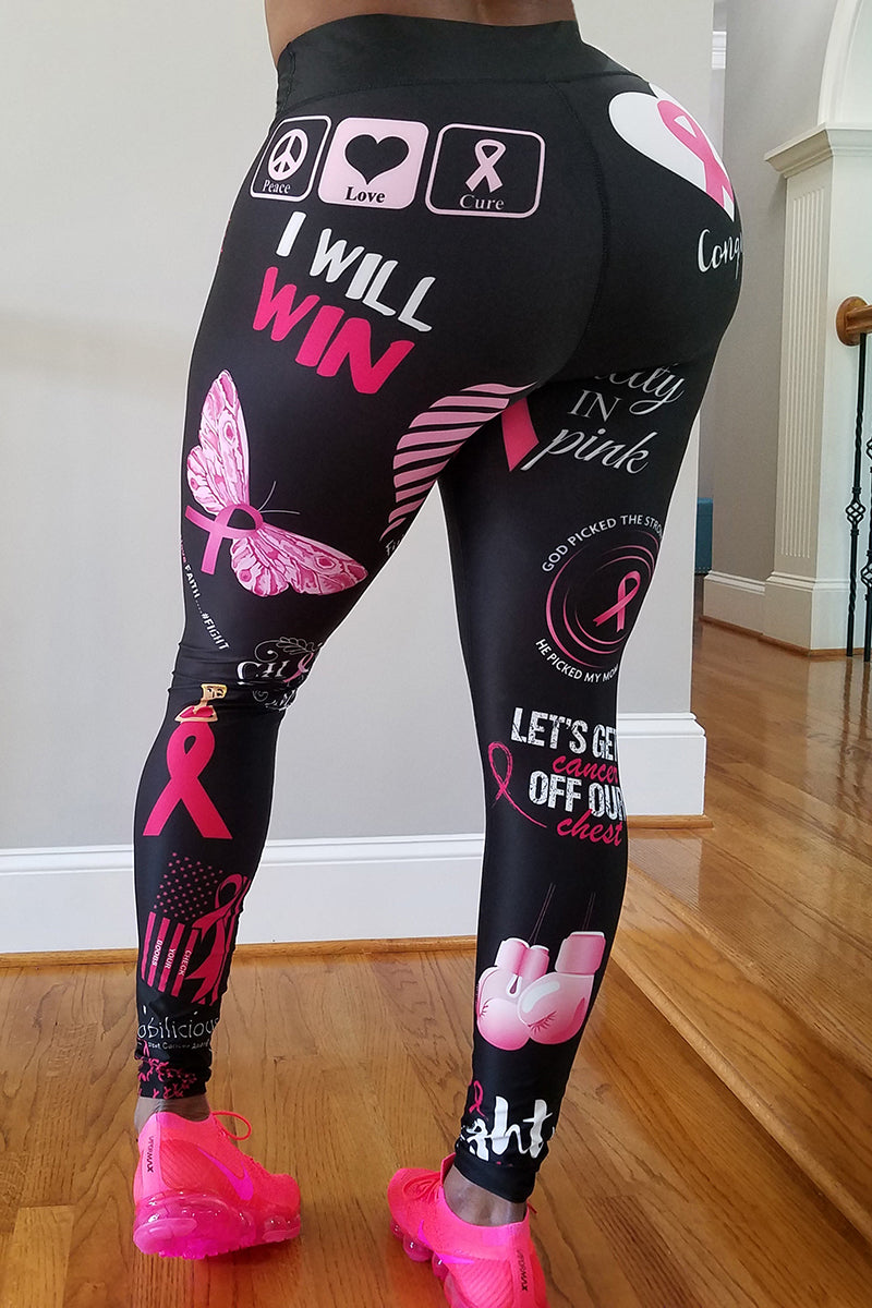 A girl wearing black tights with pink breast cancer awareness prints and pink running shoes.