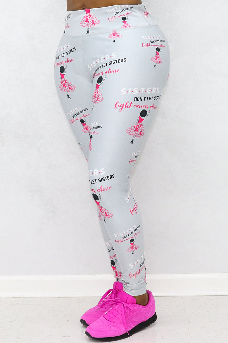 A woman wearing Sisters Don't Let Sisters Tights in silver, featuring a stylish design that promotes Breast Cancer awareness while providing comfort for various activities.