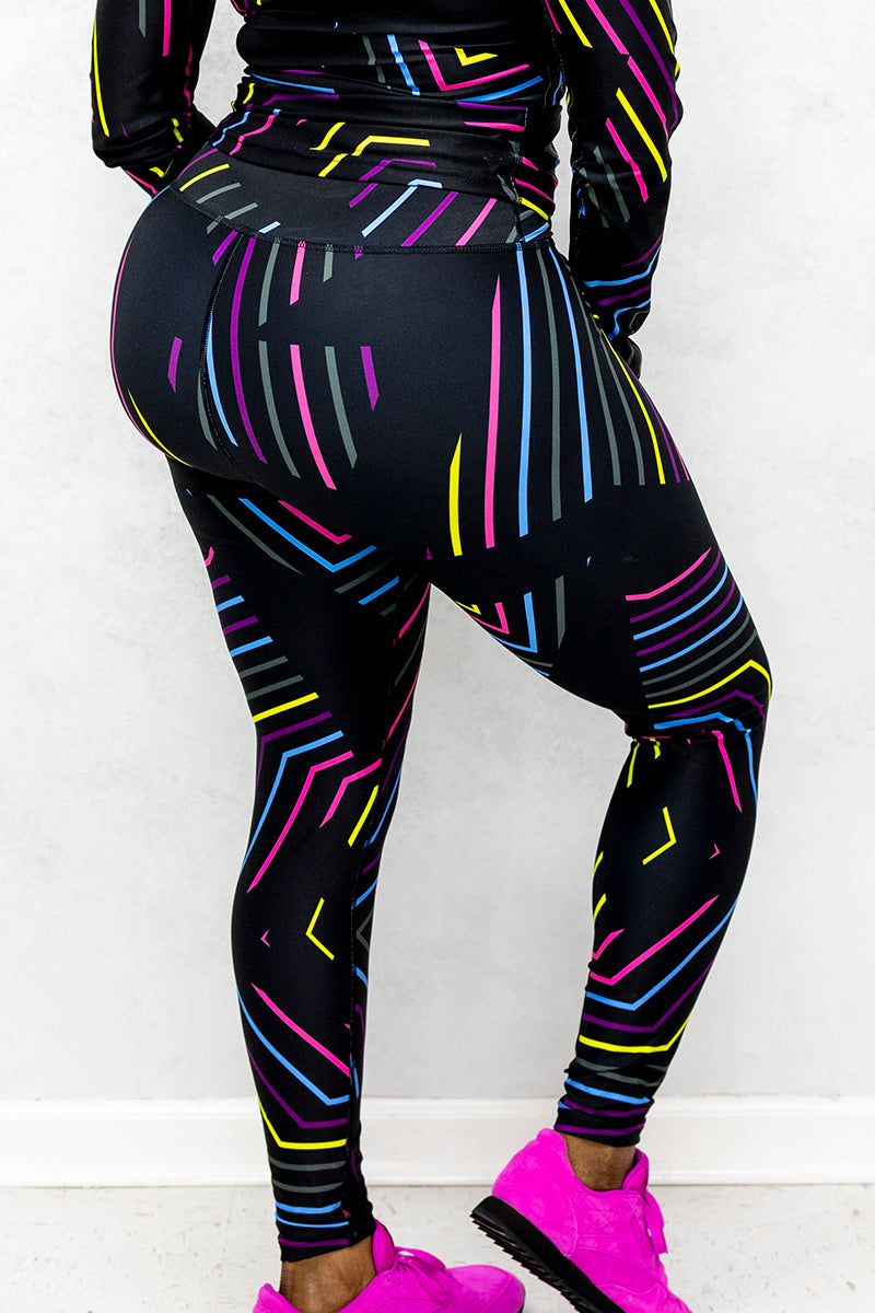 A woman wearing Multi-colored tights featuring a playful candy tights inspired design.