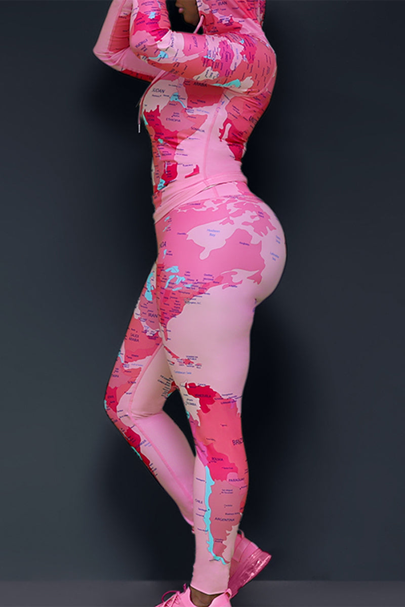 A woman wearing a fitted fitness pink pullover and matching tights printed with world's map design with pink sneakers. The pullover has pink drawstrings