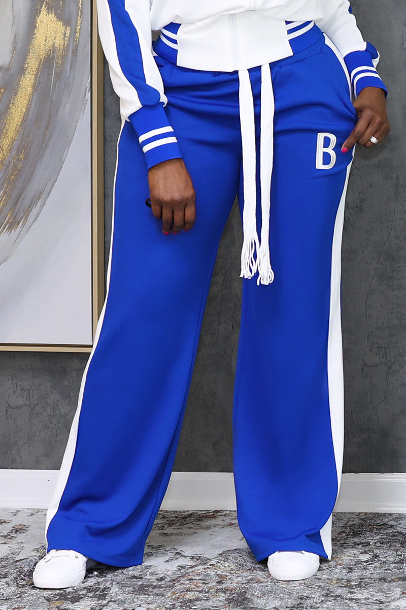 A woman wearing White and blue B-Girl sweatpants featuring a casual, sporty design.