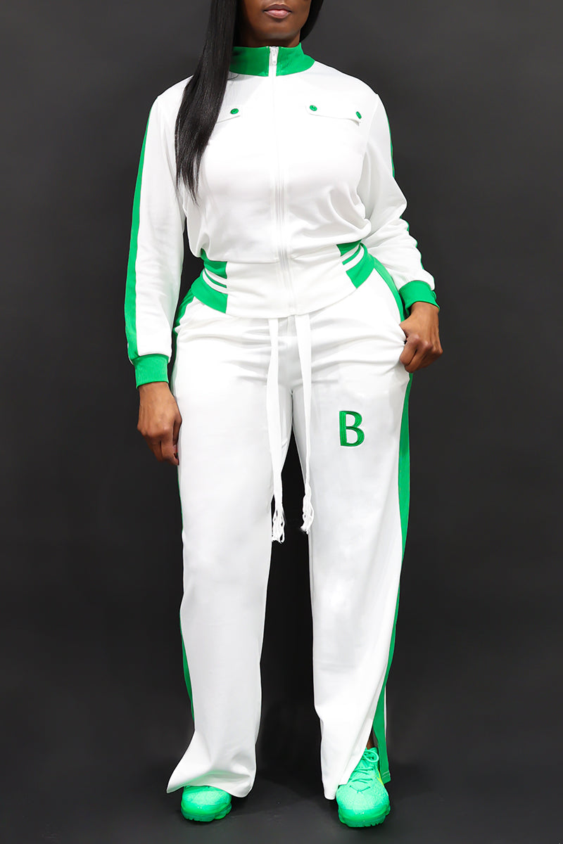 A happy woman wearing White and green B-Girl sweatpants with a comfortable, sporty style.