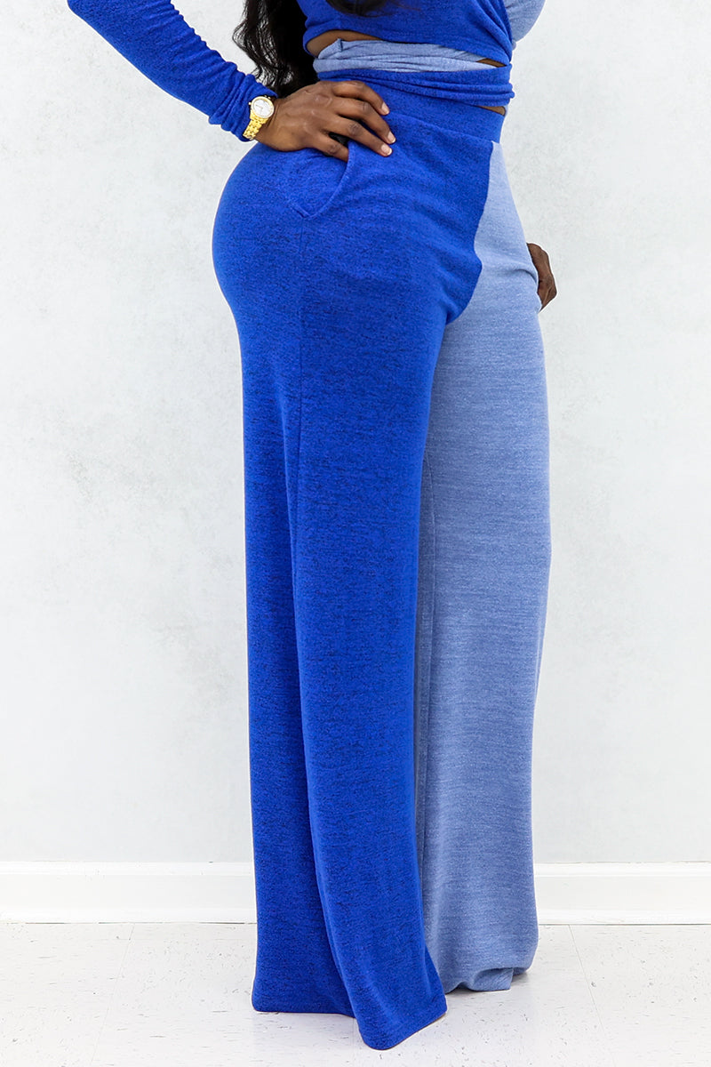 A woman wearing Blue wide-leg pants with sky blue side panels for a trendy style.