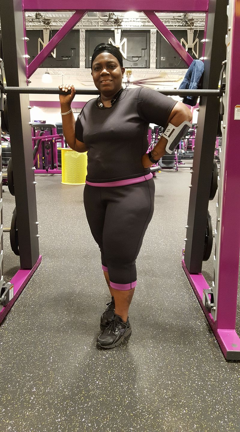 A woman wearing Black and purple trimmer top designed for a stylish and athletic fit.