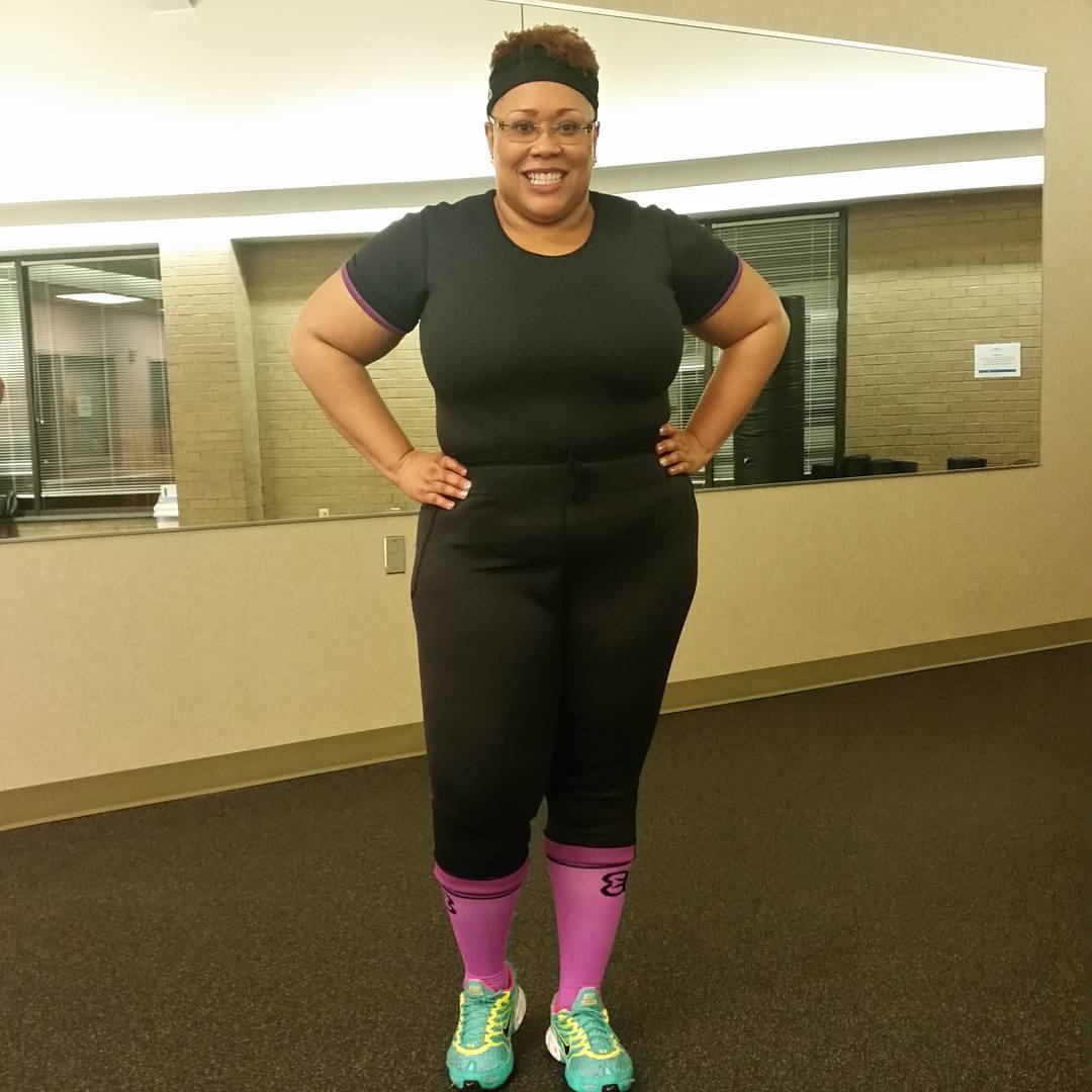 A woman wearing Black and purple trimmer top designed for a stylish and athletic fit.