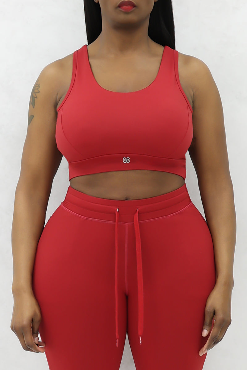 A beautiful woman wearing a red cherry Flex sports bra.