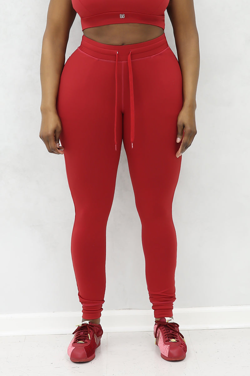 A beautiful woman wearing red cherry Flex fitted joggers.