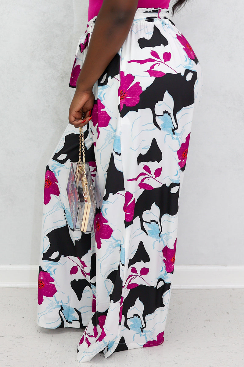 A beautiful woman wearing multi-colored floral palazzo pants.