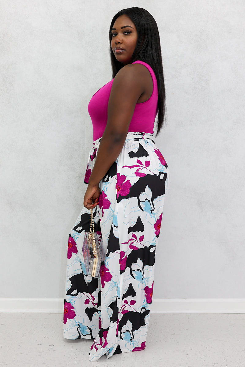 A beautiful woman wearing multi-colored floral palazzo pants.