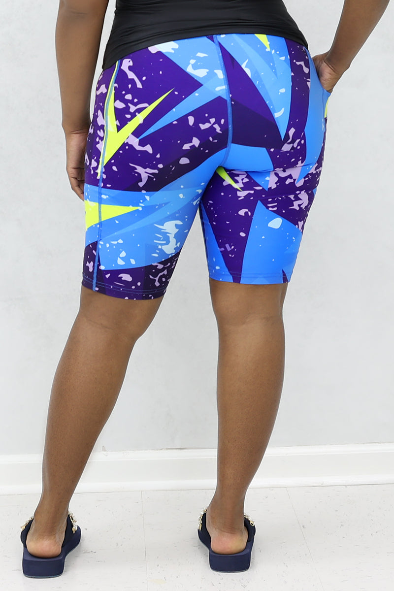 A stylish woman wearing multi-colored Fusion shorts.