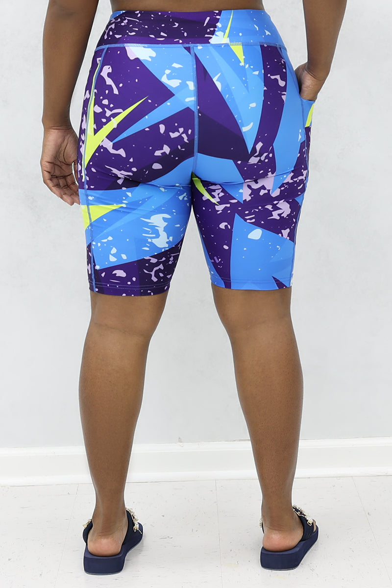 A stylish woman wearing multi-colored Fusion shorts.