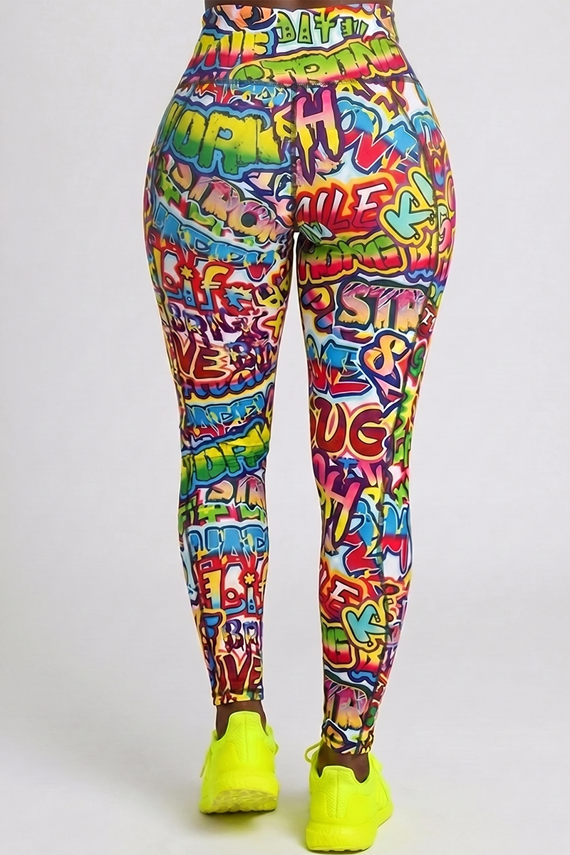 A person stands with their back to the camera, wearing Graffiti Tights and bright yellow sneakers against a plain light background.