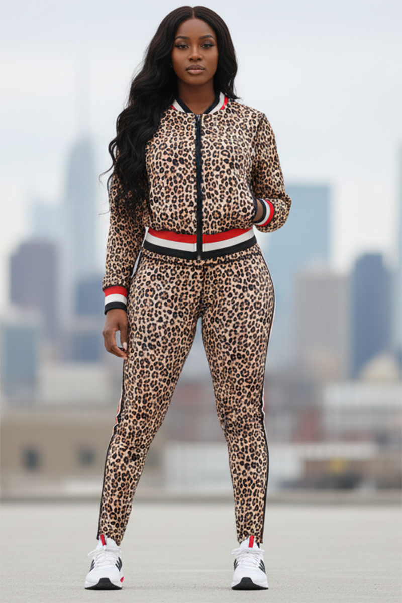 A woman stands outdoors in Ona High-Waisted Tights and a matching leopard print tracksuit, paired with white sneakers. She faces forward with long, wavy hair, and a city skyline is blurred in the background.