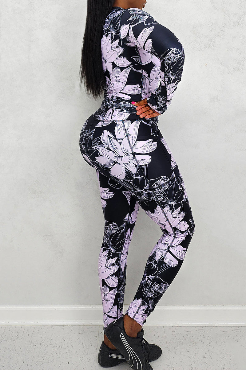 A woman wearing floral lavender and black tights, showcasing a stylish and versatile addition to her wardrobe that enhances her outfit with a bold pattern.