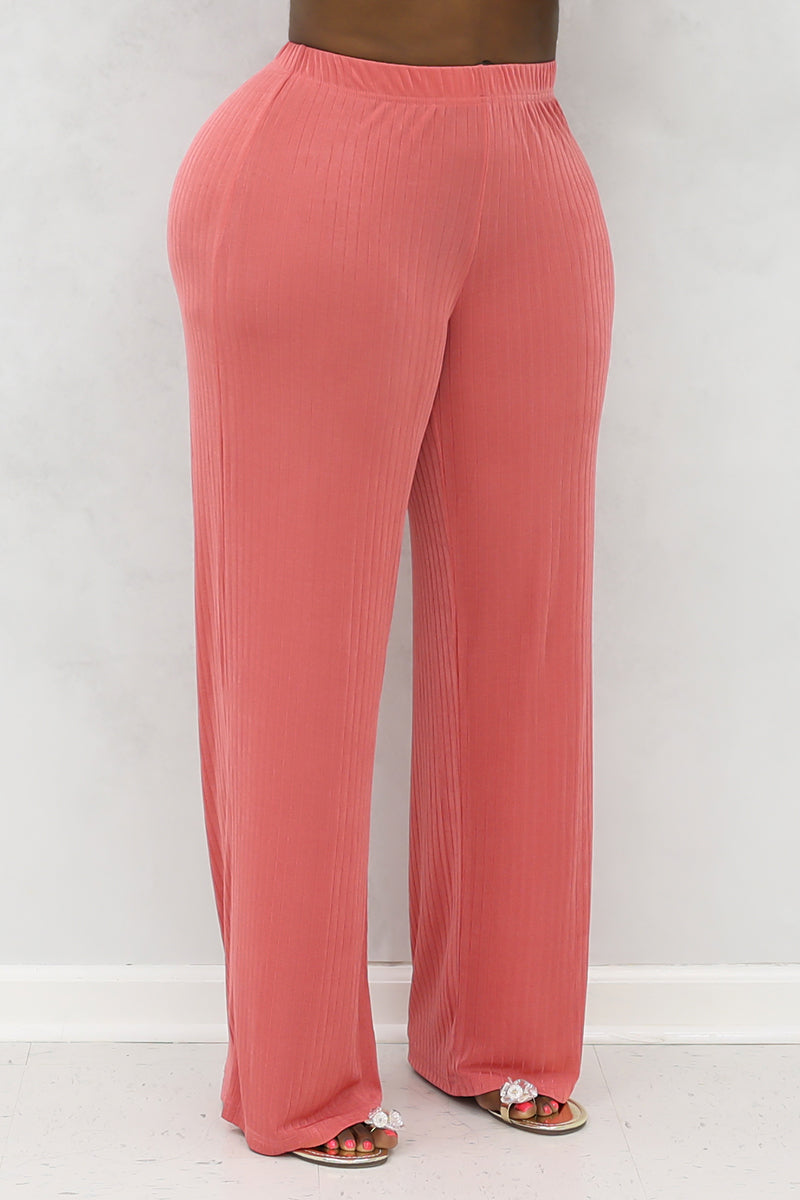 A woman wearing loose-fit mauve pants made of stretchy spandex and polyester, featuring an elastic waistband. The lightweight fabric allows for plenty of movement, while reflective stripes on the shoulders, arms, and back enhance visibility for outdoor exercise.