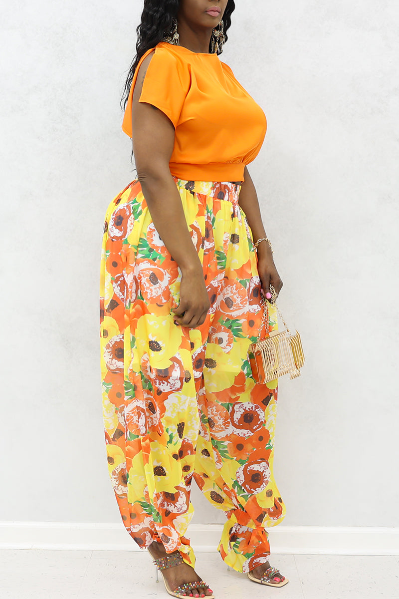 A woman wearing an Open Back Crop Top in vibrant orange, featuring a stylish open back design, perfect for warm-weather outfits.