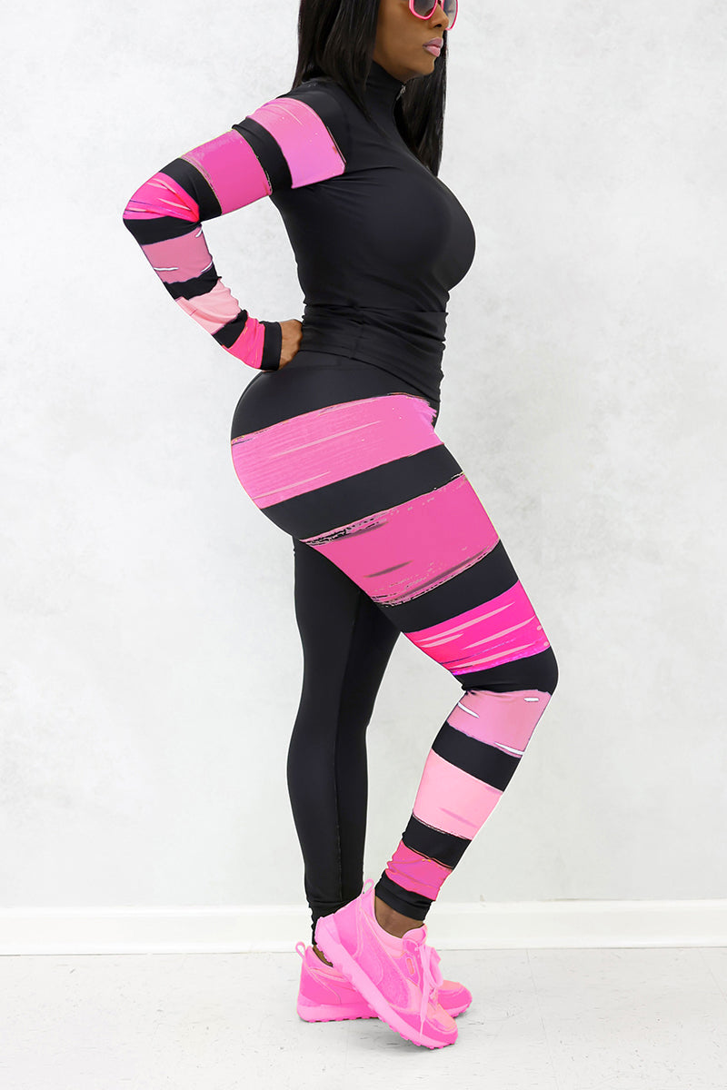 A woman wearing the Paint Strokes Limited Edition Tights in black and pink, featuring a pocket on the left thigh and a continuous drawstring, designed in support of National Breast Cancer Awareness Month.