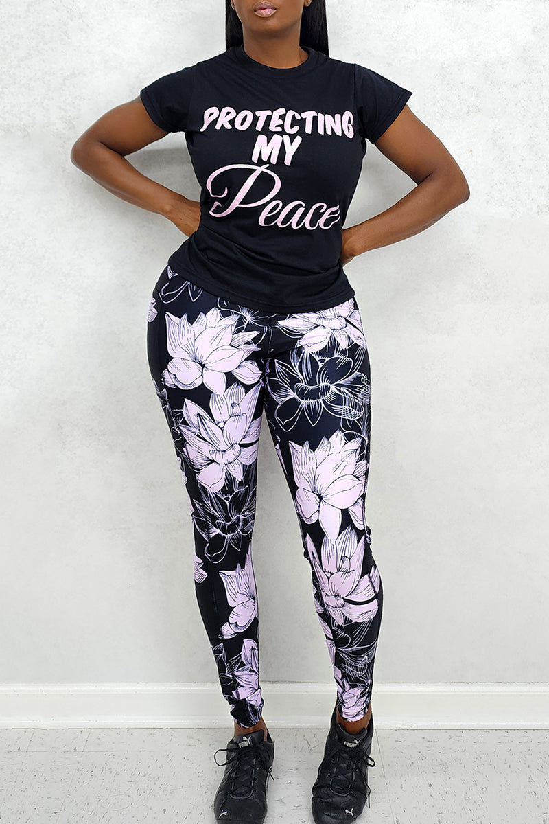 A woman wearing a tank top and floral lavender and black tights, playfully expressing "protecting my peach with these tights." The stylish tights feature a bold floral pattern, adding flair to her outfit and making it a versatile addition to her wardrobe.