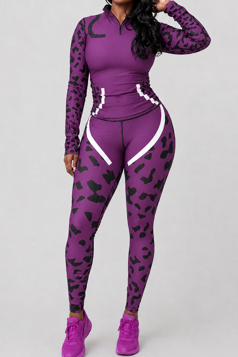 A person stands against a plain background wearing the Purple Leopard Tights, a pair of purple and black animal print athletic tights made from polyester spandex for a body-contouring fit. The tights feature white accents near the hips and thighs for added style and are paired with a matching long-sleeve zippered top and sneakers.