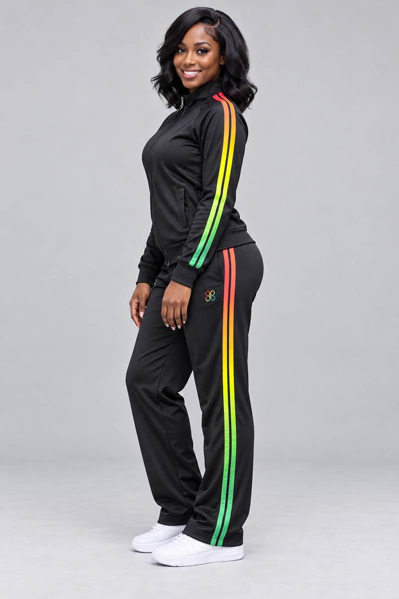 A plus size woman wearing a black, loose-fit Juneteenth Track Jacket and matching pants with red, yellow, and green side stripes, paired with white sneakers.