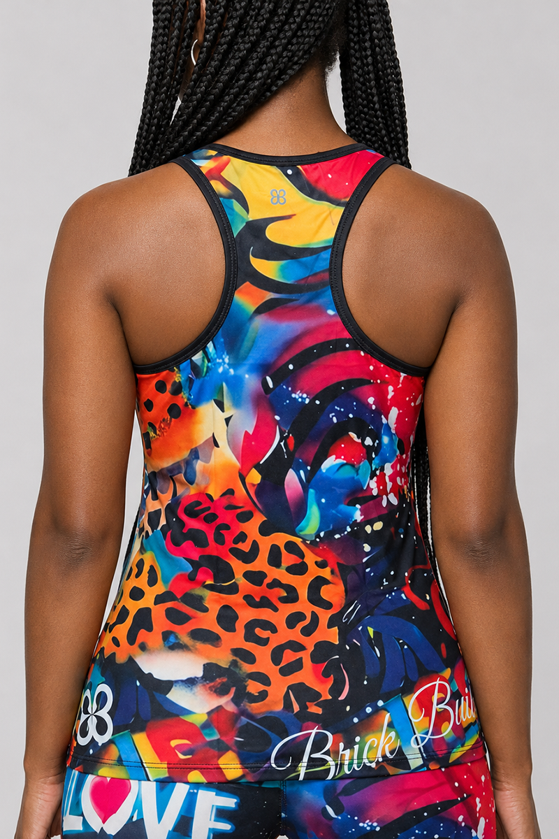 A person with braided hair is shown from the back, wearing the Art Code Tank Top—a lightweight racerback made from breathable fabric, featuring a mix of abstract and animal print patterns as well as graffiti-style text.