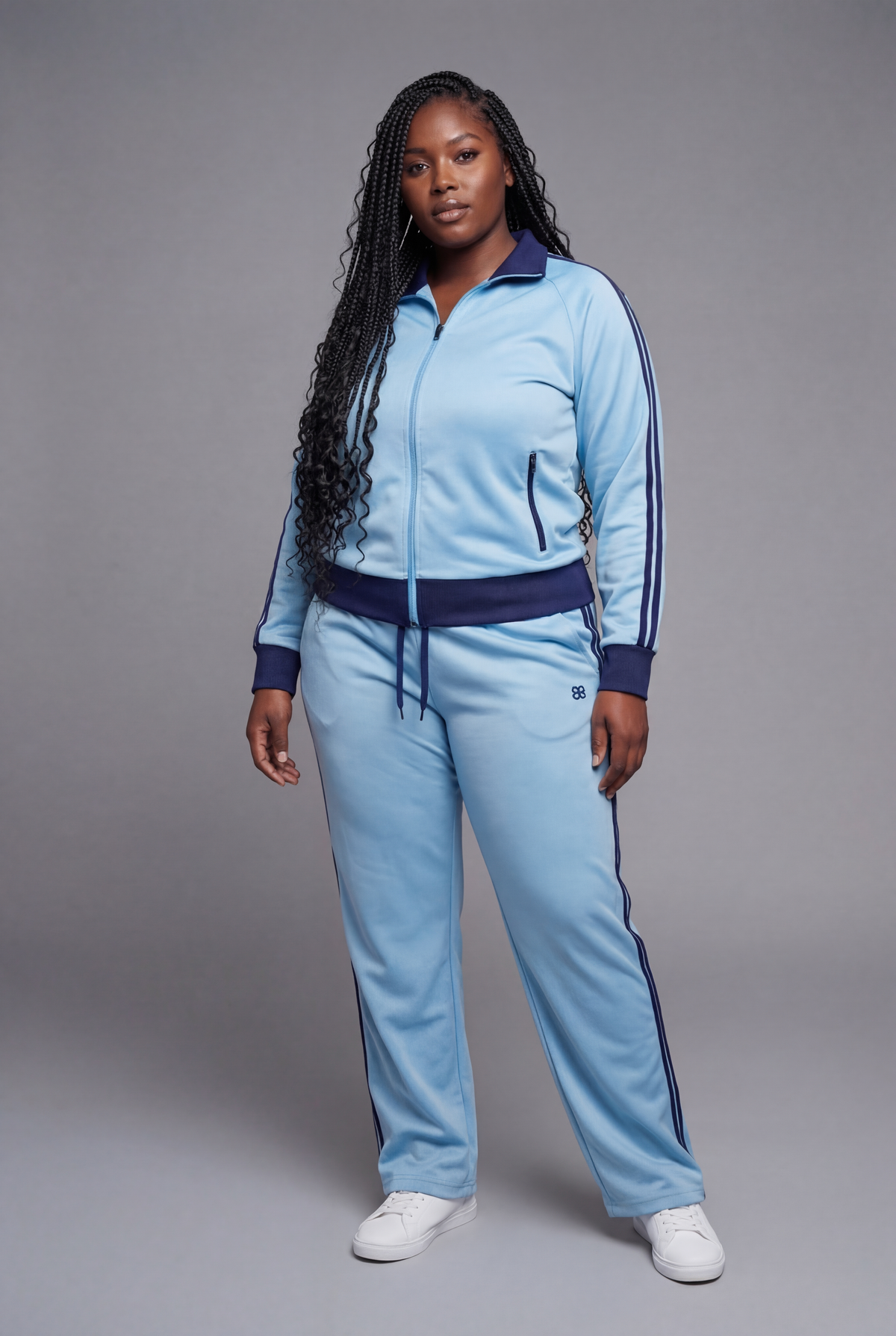 Front view of a light blue tracksuit with navy trim, side stripes, and white sneakers.
