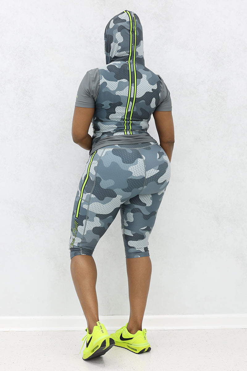 A woman wearing Grey and black camo capri pants with a trendy, casual design.