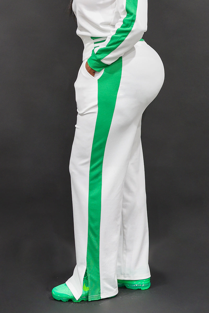 A happy woman wearing White and green B-Girl sweatpants with a comfortable, sporty style.