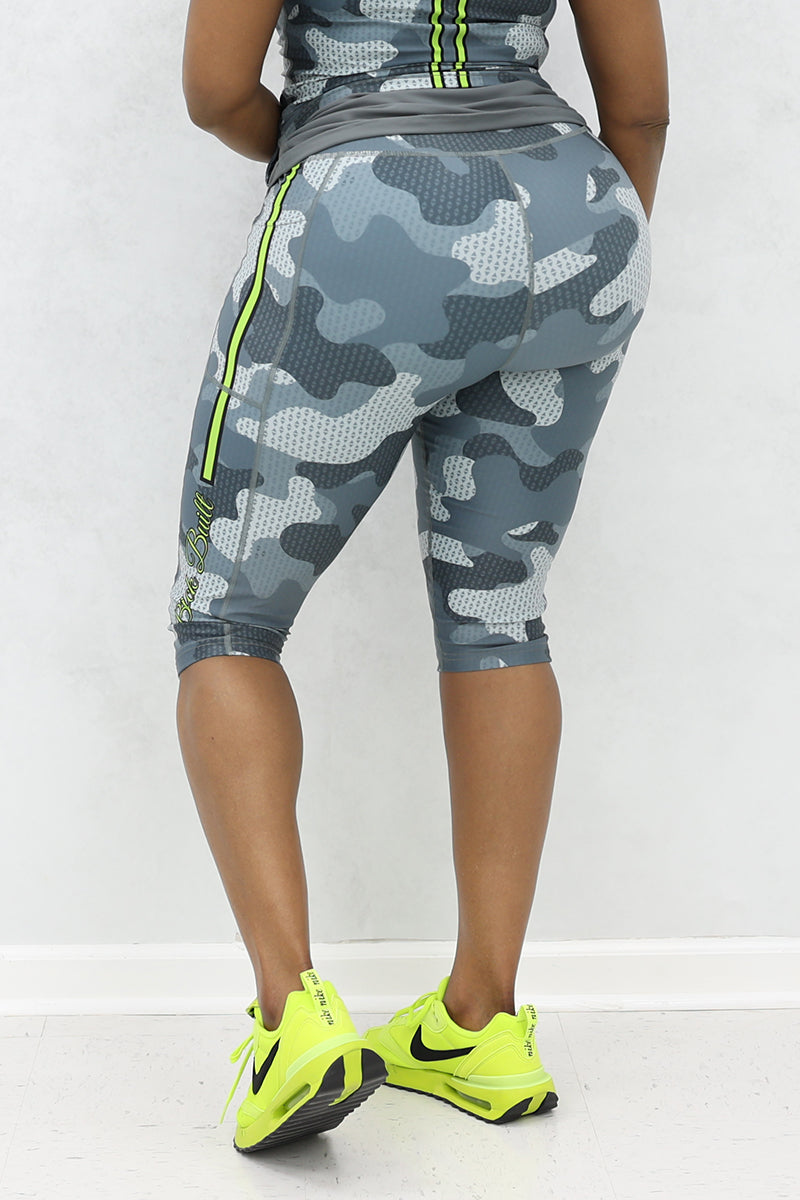 A woman wearing Grey and black camo capri pants with a trendy, casual design.